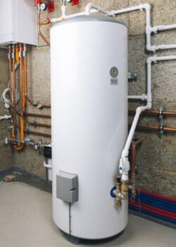 white storage tank water heater in boiler room