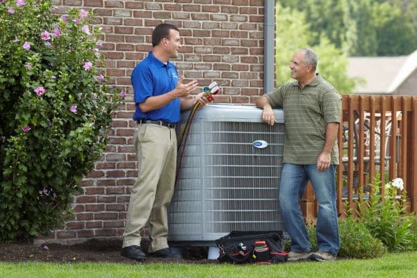 two men outside talking about the costs of a new hvac system